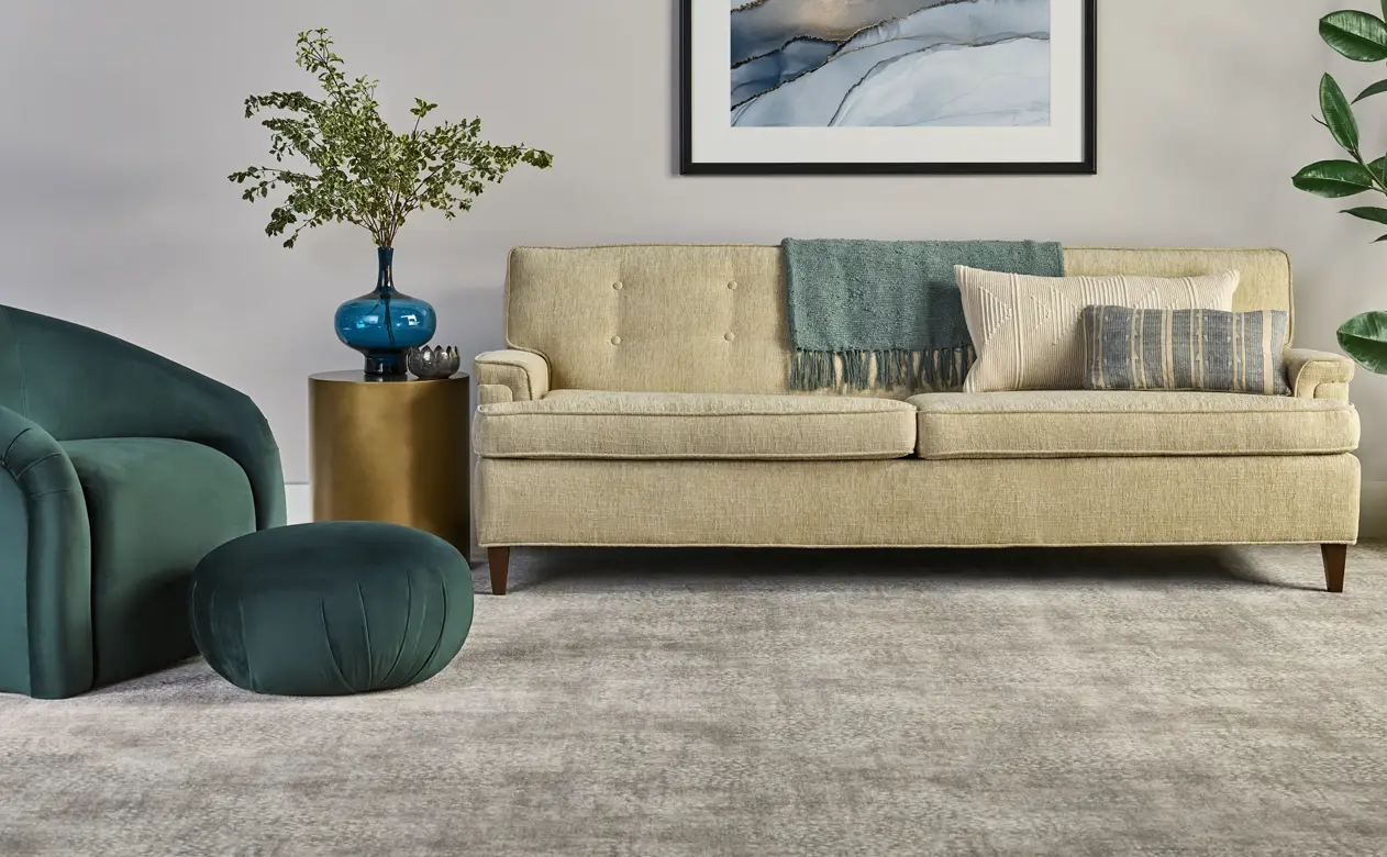 greyish velvet plush carpet with green chair and puff.